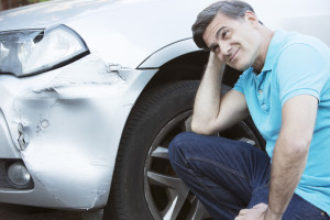 Man thinking about car damage from accident