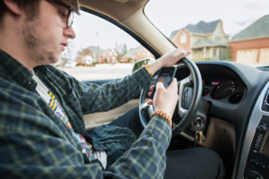 Man texting and driving car