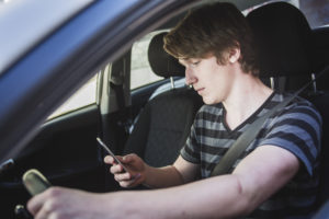 Teenage boy texting and driving